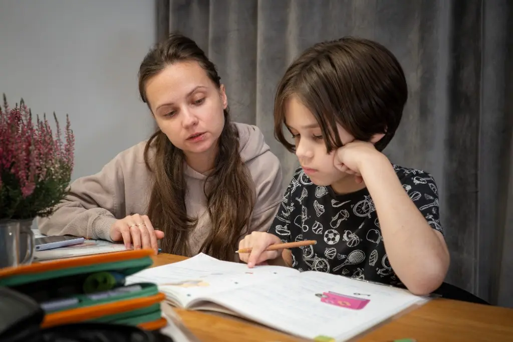Parent studying with their child at home