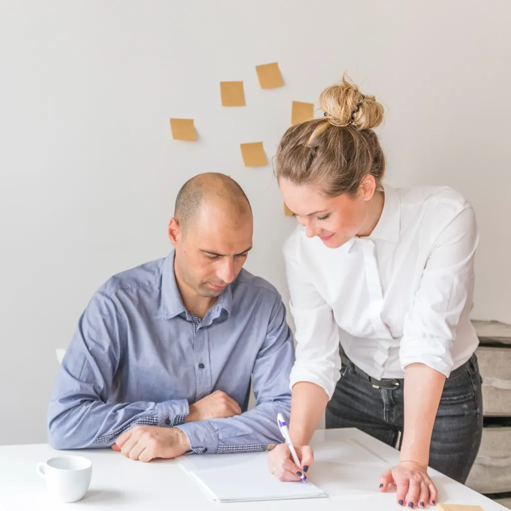 Clinician and client reviewing notes together at a desk
